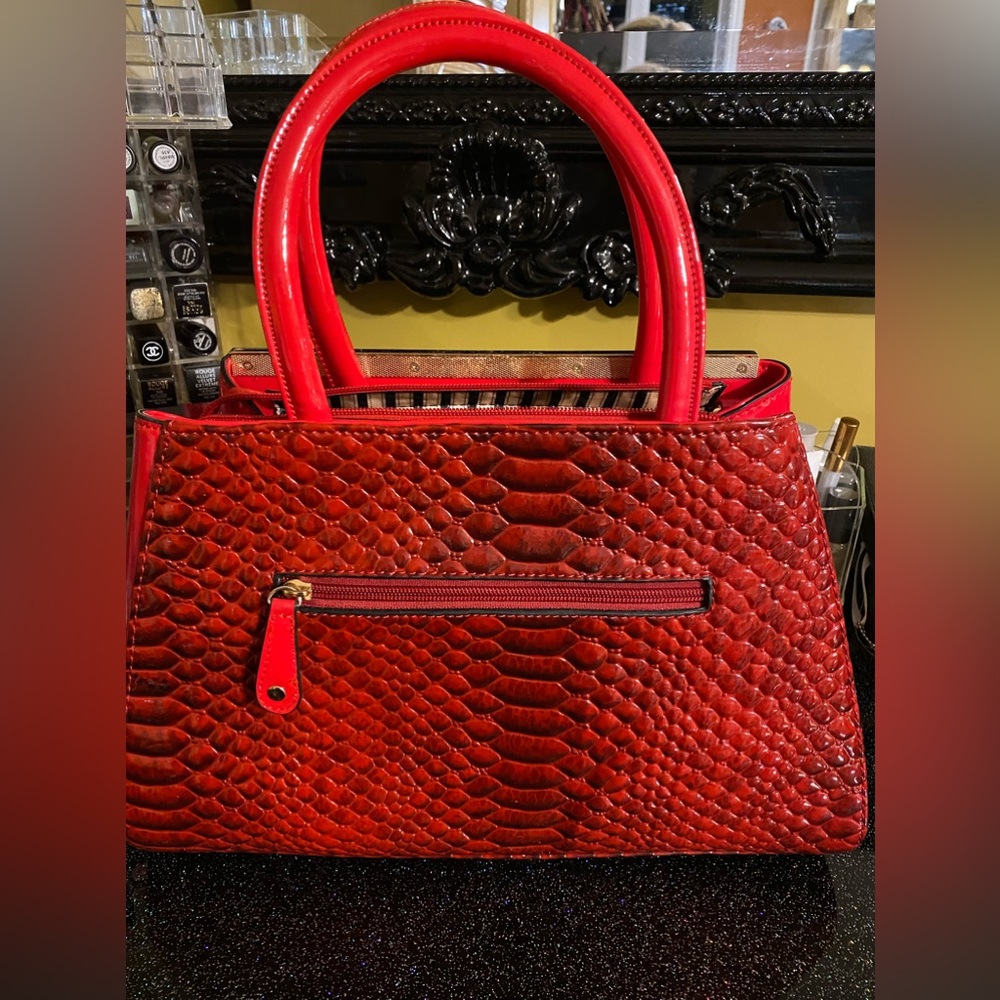 Beautiful patent textured red hand bag with strap. Used once